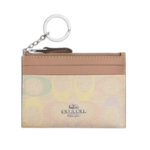 A Coach card holder with a keychain, featuring a multicolored pastel pattern and a front logo. It includes a zippered pocket and card slots.