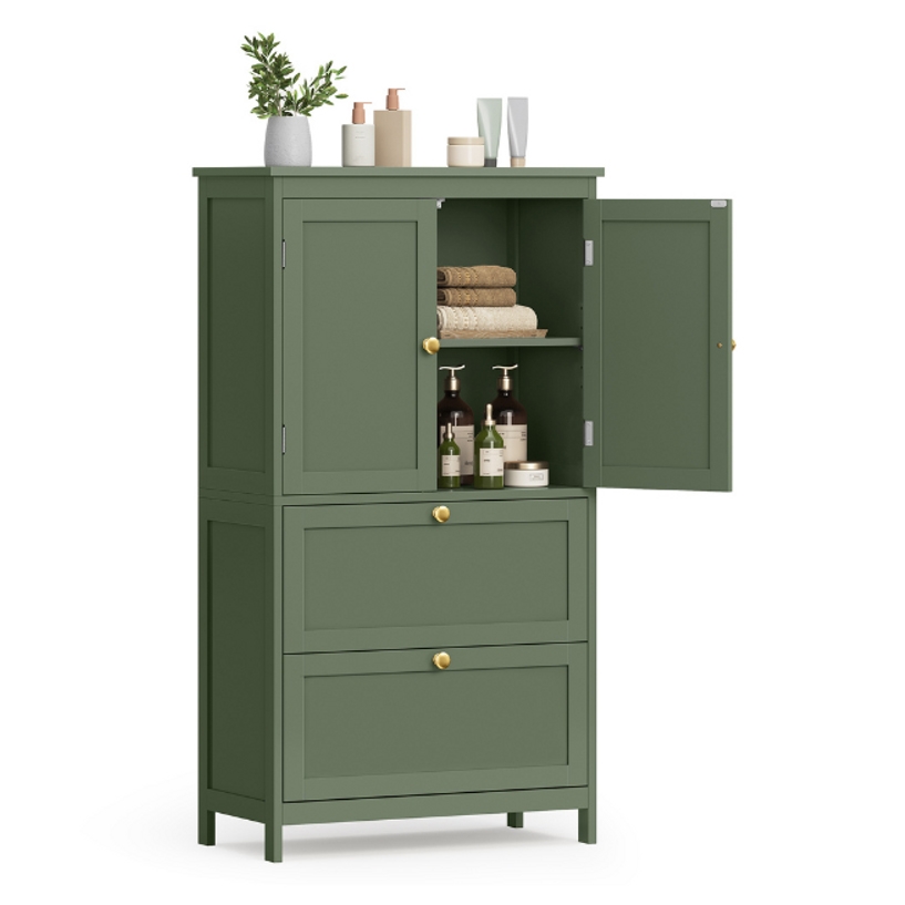 Green bathroom storage cabinet with gold knobs featuring two upper cabinet doors, one open revealing towels and toiletries, and two lower drawers. Decor includes plants and various bottles on top.
