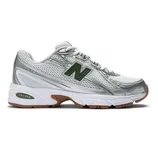 A white and silver New Balance sneaker with green accents, featuring a mesh upper, gum sole, and ABZORB cushioning technology.