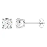 A pair of stud earrings featuring round-cut clear gemstones set in a four-prong metal setting with a straight post and butterfly back closure.
