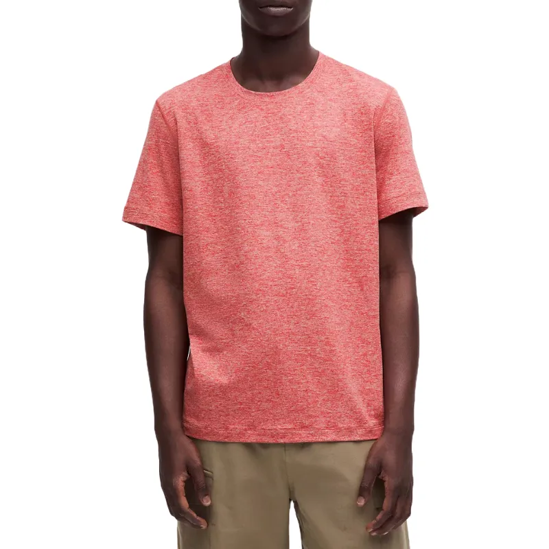 A short-sleeve, crew-neck men's shirt in a soft, lightweight jersey fabric with a heathered red color, paired with beige pants.