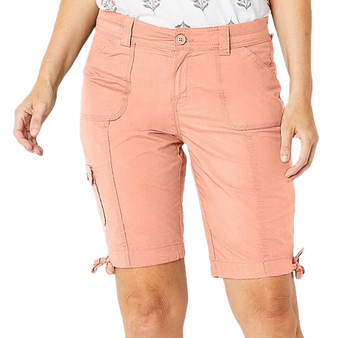 Peach-colored cargo shorts with side pockets, a button closure, and adjustable ties at the hem, paired with a floral patterned top.