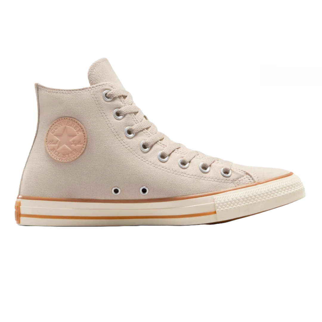 Converse high-top sneakers featuring a beige canvas upper, leather logo patch, and metal eyelets, with a textured rubber sole and a beige and white midsole trim.