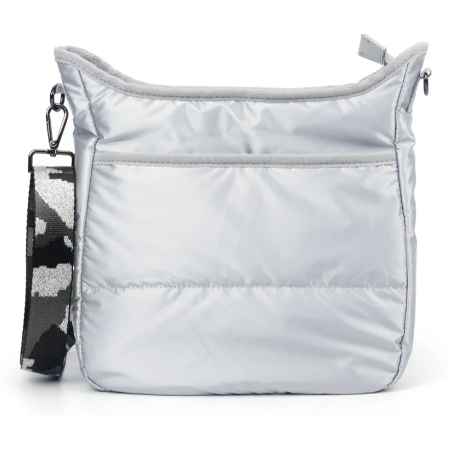 A silver quilted shoulder bag with a front pocket and a detachable black-and-white camo-patterned strap.