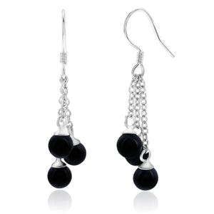Silver dangling earrings with three black spherical beads hanging from each earring via small chains.