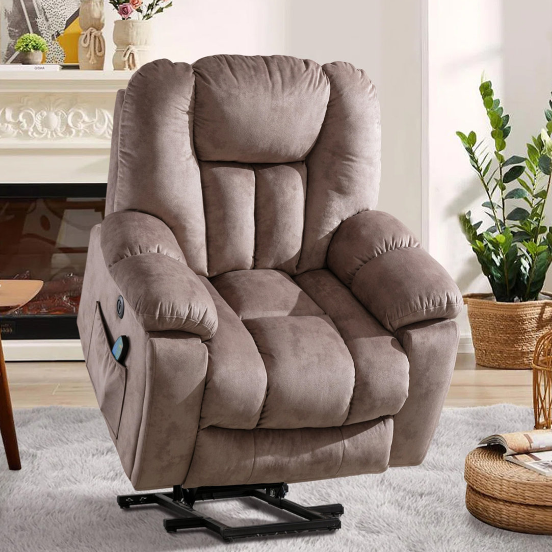 A brown plush recliner chair with a lift mechanism is set in a cozy living room, featuring a light carpet, a coffee table, and potted plants.