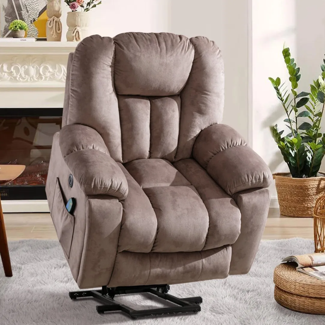 A brown plush recliner chair with a lift mechanism is set in a cozy living room, featuring a light carpet, a coffee table, and potted plants.