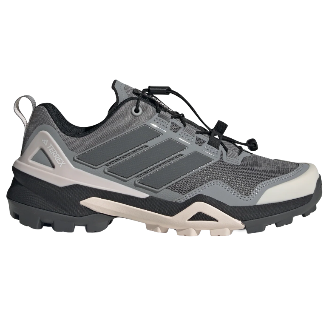 Adidas Terrex hiking shoe in gray with a rugged sole, featuring a mesh upper and signature three stripe design.