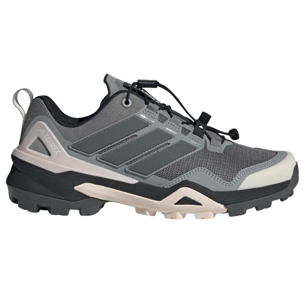 Adidas Terrex hiking shoe in gray with a rugged sole, featuring a mesh upper and signature three stripe design.
