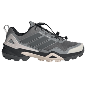 Adidas Terrex hiking shoe in gray with a rugged sole, featuring a mesh upper and signature three stripe design.