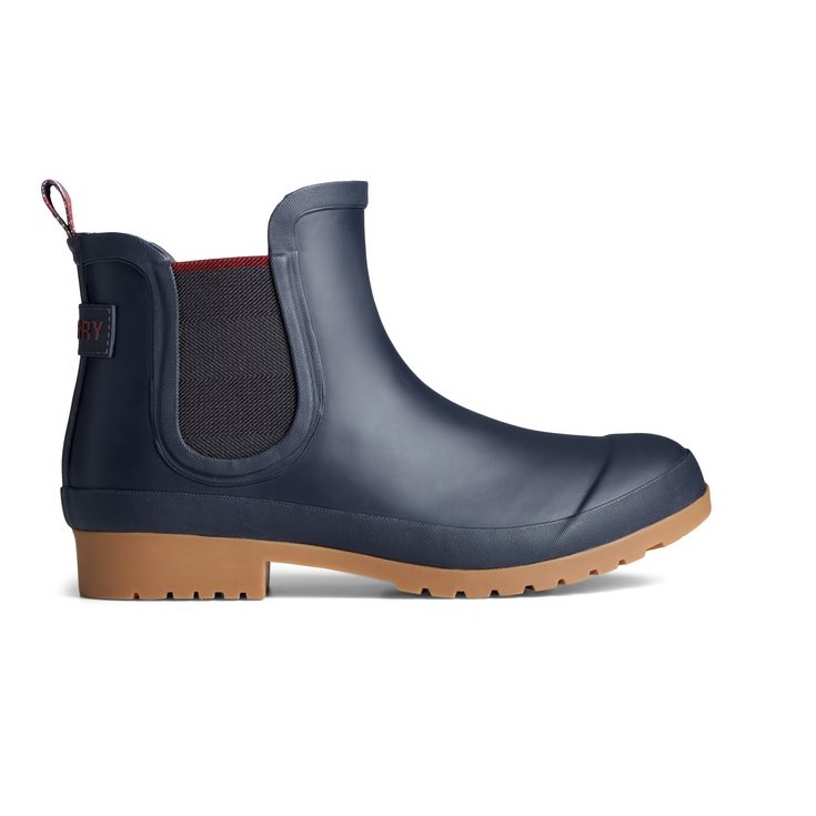 A navy blue waterproof Chelsea boot with a black elastic side panel and a tan non-slip sole.