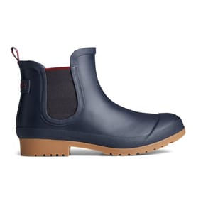 A navy blue waterproof Chelsea boot with a black elastic side panel and a tan non-slip sole.