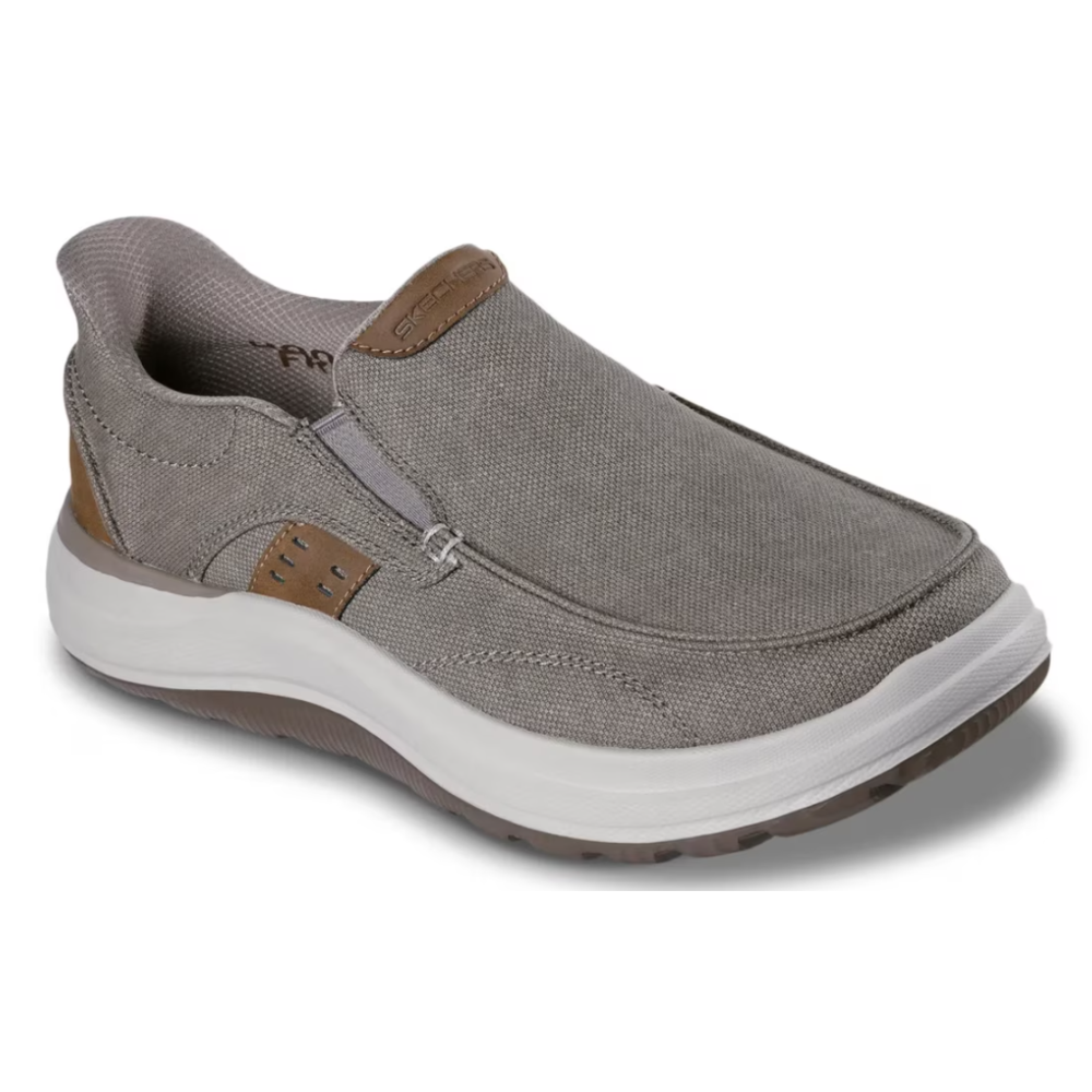A slip-on shoe with a gray fabric upper and white cushioned sole, featuring elastic side panels and branded detailing on the tongue.