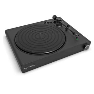 Victrola Stream Onyx Turntable is a sleek, modern record player with a minimalistic black design, featuring a circular platform, tonearm, and control knobs. It integrates seamlessly with wireless audio systems for easy listening.