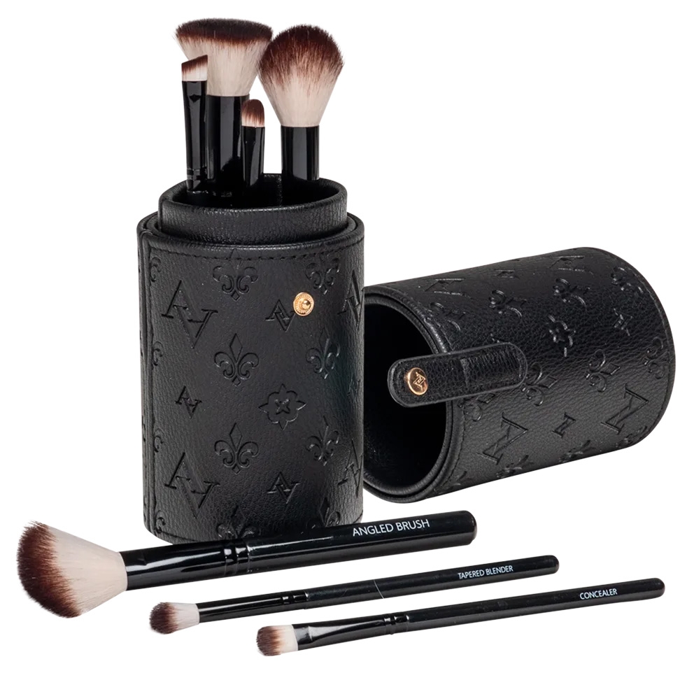 A 7-piece makeup brush travel set in a black, embossed leather case with a snap closure. Brushes visible include angled, tapered blender, and concealer brushes, all with black handles and synthetic bristles.