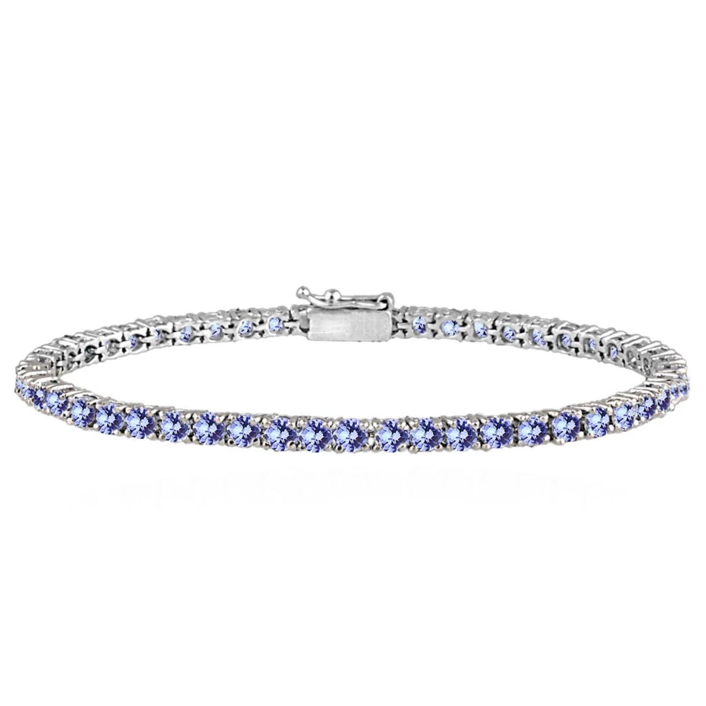 A tennis bracelet featuring a single row of blue gemstones, likely sapphires, set in a silver-toned or white gold metal band with a secure clasp.