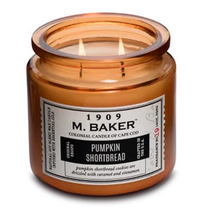 M. Baker candle, \“Pumpkin Shortbread\“ scent, 14 oz, features natural soy blend wax with essential oils, described as having notes of caramel and cinnamon.