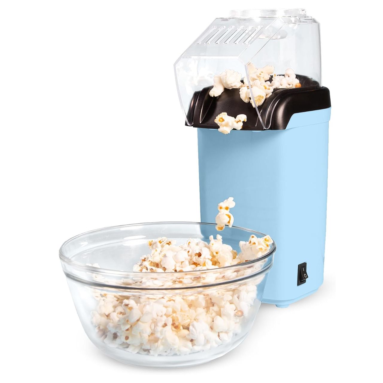 A light blue electric popcorn maker with a transparent lid is shown, dispensing popcorn into a glass bowl. The device features a simple on/off switch and an angled spout for directing popped corn.