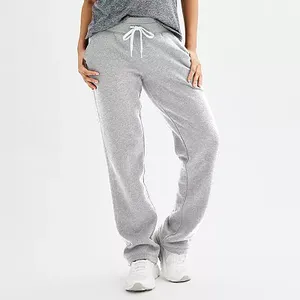 Gray fleece sweatpants with a drawstring waist and relaxed fit, paired with white sneakers.