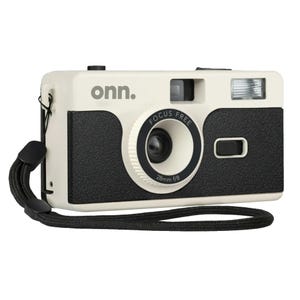 A beige and black Onn focus-free film camera with a 28mm f/8 lens and built-in flash, featuring a wrist strap for portability.