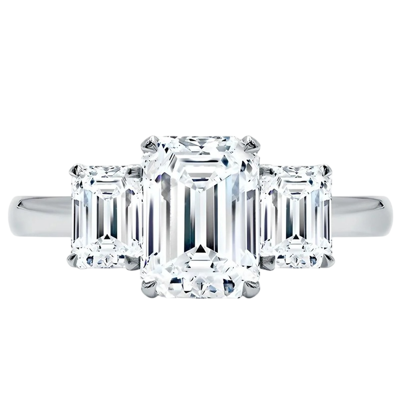 Three-stone ring with an emerald-cut center diamond flanked by two smaller emerald-cut diamonds, all set in a sleek metal band.