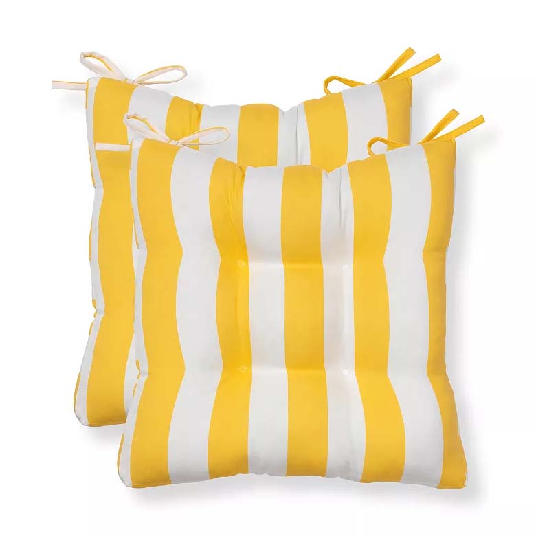 Two yellow and white striped cushioned chair pads with tie strings for secure attachment.