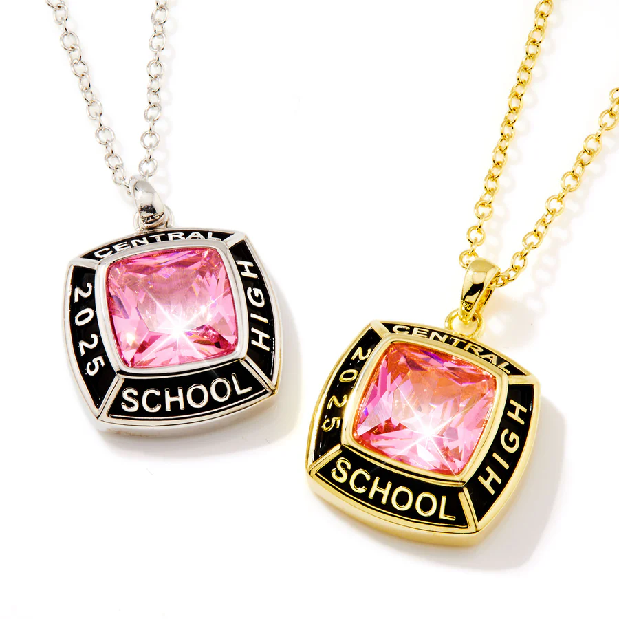 Two class pendants with pink stones and inscriptions reading \“Central High School 2025\“ are shown. One pendant has a silver-tone finish with a silver chain, while the other features a gold-tone finish with a gold chain.