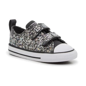 Black sneaker with a multicolored speckled design, featuring two Velcro straps and a white rubber toe cap and sole.