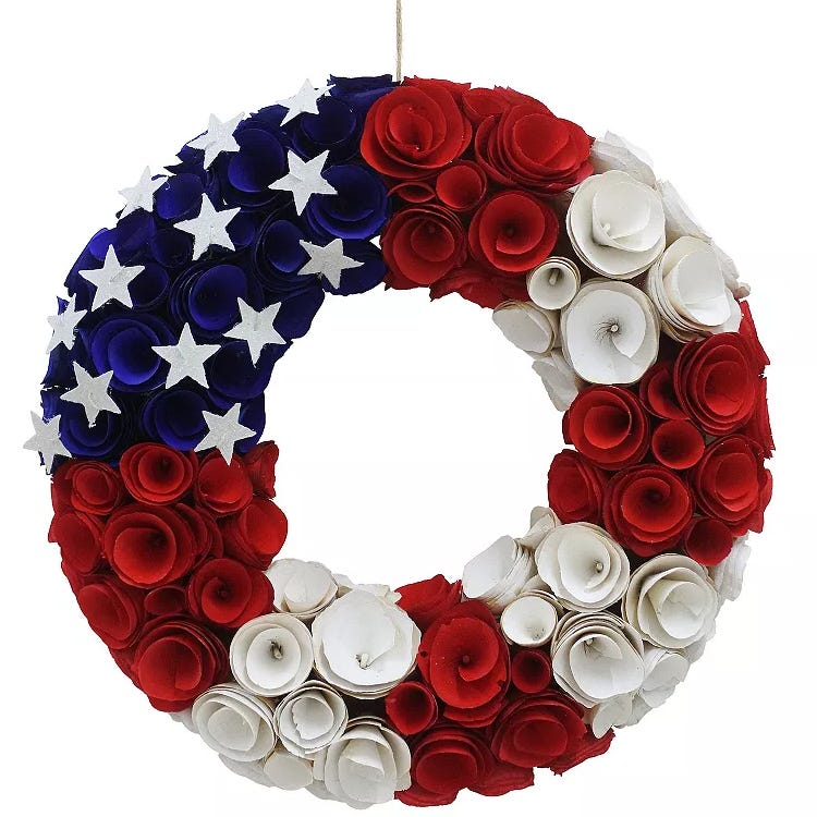 Patriotic wreath featuring red, white, and blue paper roses with white stars, designed to resemble the American flag.