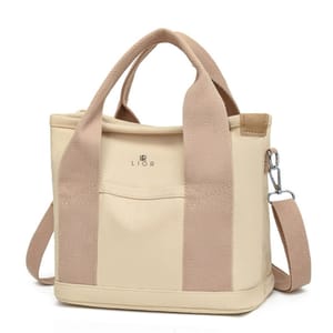 Beige canvas tote with tan handles and an adjustable strap, featuring a front pocket and metal hardware. The brand name \“LIOR\“ is printed on the front.