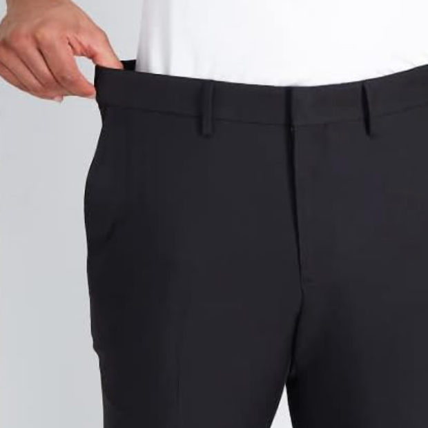 A person is partially visible wearing black dress pants.