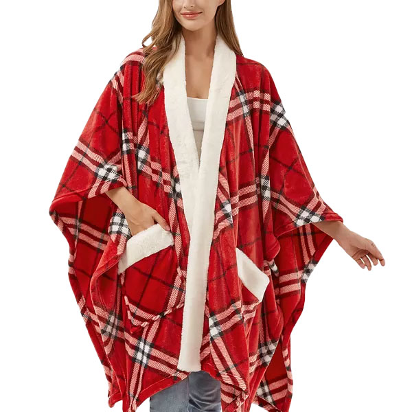 A woman is wearing a red plaid poncho with white sherpa lining and pockets.
