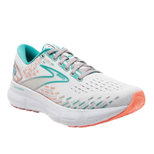 White and teal running shoe with a breathable mesh upper, cushioned sole, and orange accents. Features include lace-up closure, logo detailing, and a rubber outsole designed for comfort and flexibility.