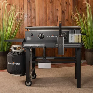 Blackstone flat top gas grill with side shelves, a front grease management system, and a propane tank holder.