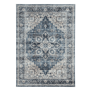 A rectangular area rug with a distressed vintage design, featuring intricate floral and geometric patterns in shades of blue, cream, and gray.