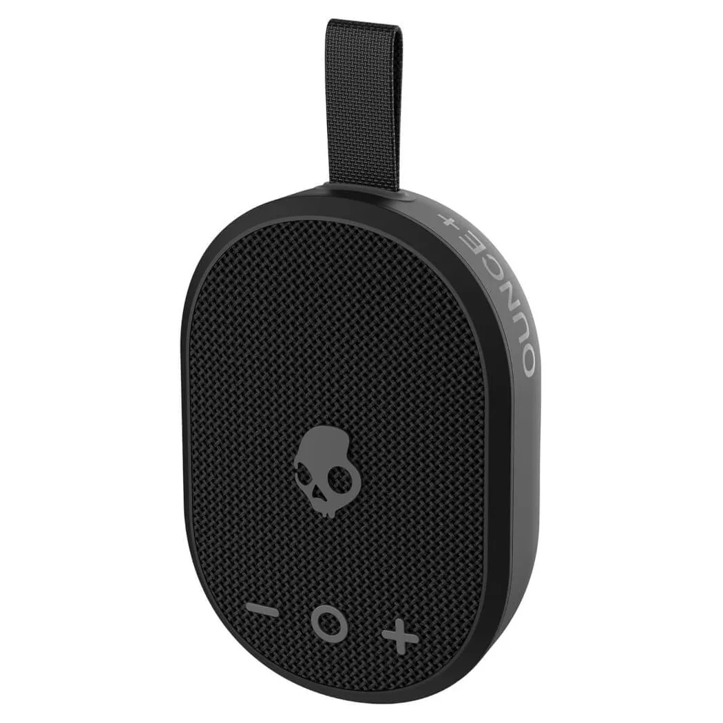 Black oval-shaped portable speaker with a skull logo and volume control buttons, equipped with a strap.