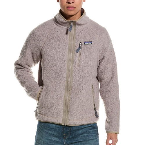A person is wearing a beige fleece jacket with a chest zipper pocket and two side zipper pockets, paired with jeans.