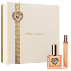 Dolce & Gabbana fragrance gift set featuring a heart-embellished square bottle and a slim travel-sized spray, presented in a cream box with gold accents.
