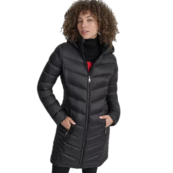 A woman models a black, mid-length quilted down coat with a hood. The coat features a zipper closure and two zippered pockets.
