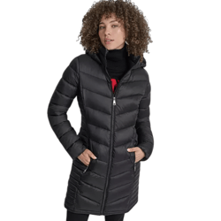 A woman models a black, mid-length quilted down coat with a hood. The coat features a zipper closure and two zippered pockets.