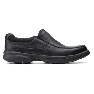 A black slip-on shoe with a sturdy rubber sole and leather upper, featuring subtle stitching and a minimalist design.