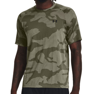 A man wearing a camouflage t-shirt with the Under Armour logo on the chest.