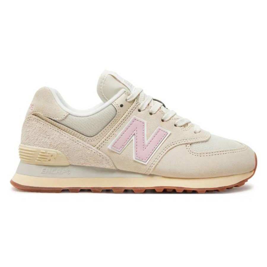 New Balance Linen 574 Low-Top Sneakers feature a light beige suede and mesh upper with a soft pink \“N\“ logo, cushioned midsole, and gum rubber outsole, designed for comfort and casual style.