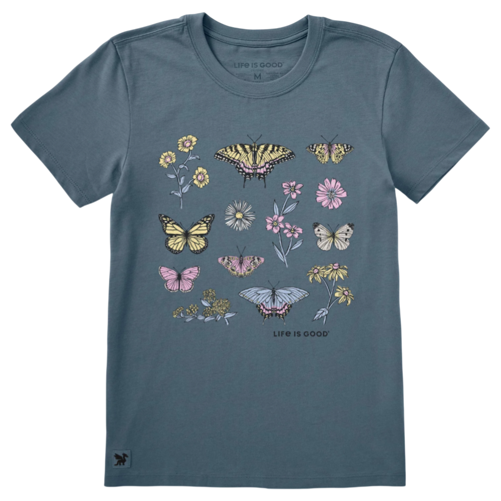 A blue T-shirt featuring illustrations of various butterflies and flowers with text that reads \“Life is Good.\“