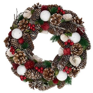 A decorative wreath featuring pinecones, red and green foliage, white balls, and red berries, with natural and snowy accents for a festive look.