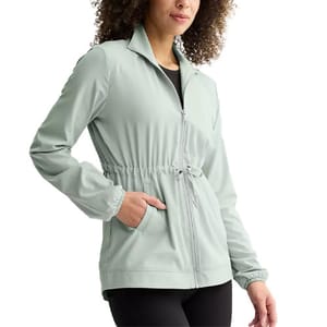 A light gray zip-up jacket with a drawstring waist and side pockets, worn by a person in black pants.