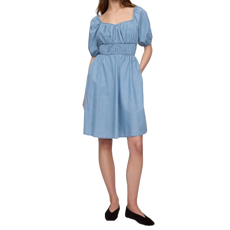 A light blue mini dress with puff sleeves, a sweetheart neckline, and a fitted ruched waist paired with black flat shoes.