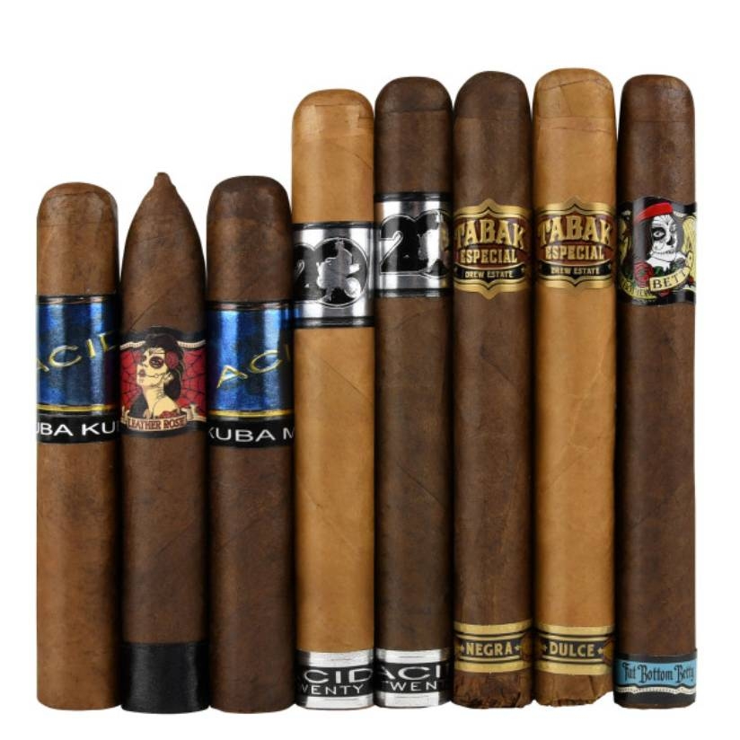 Eight Drew Estate cigars of various sizes and wrappers are displayed side by side, each with a distinctive decorative band around their midpoint.