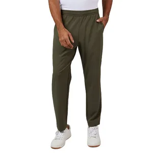 Olive green jogger pants, featuring an elastic waistband, paired with white sneakers.
