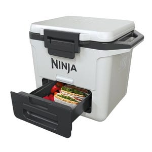 A Ninja portable appliance featuring a drawer with sandwiches and vegetables stored inside.